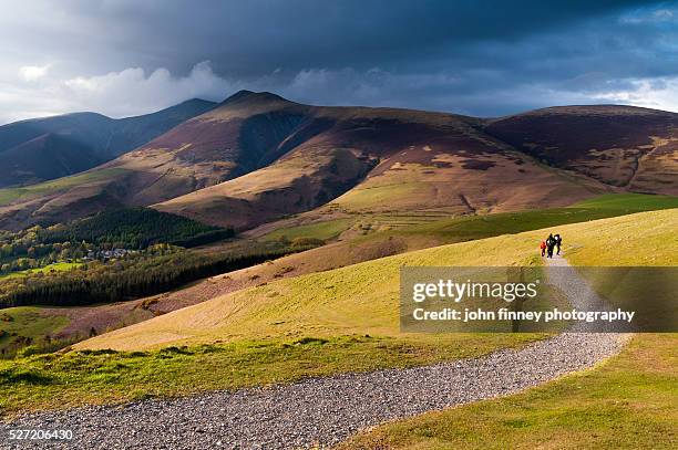 family walk along latrigg path with skiddaw mountain above. lake district national park. uk. europe. - mountain peak path stock pictures, royalty-free photos & images