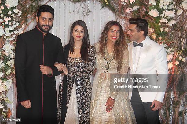 Bollywood couple Abhishek Bachchan and Aishwarya Rai Bachchan pose with newlywed couple Bipasha Basu and Karan Singh at their wedding reception on...