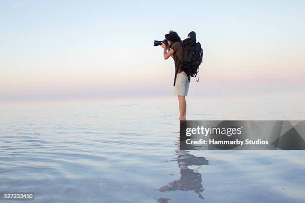 photographer taking photo on water - holiday photoshoot stock pictures, royalty-free photos & images