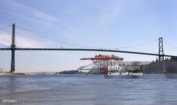 Three of the world's largest Super Post-Panamax Cranes pass under the Lions Gate bridge April 27, 2005 in Vancouver, Canada. The cranes arrived at...
