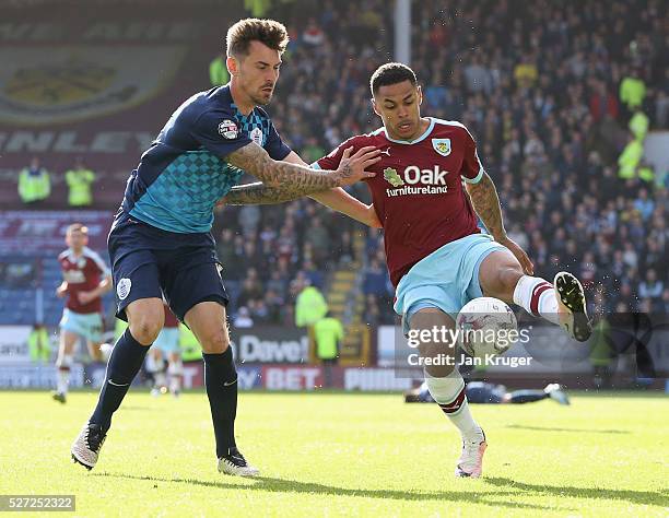 Andre Gray of Burnley holds off Grant Hall of QPR during the Sky Bet Championship match between Burnley and Queens Park Rangers at Turf Moor on May...