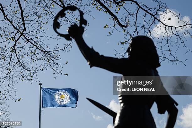 Statue of England's King Richard III is seen as a Leicester City flag flies above the Cathedral in central Leicester, eastern England, on 2 May,...
