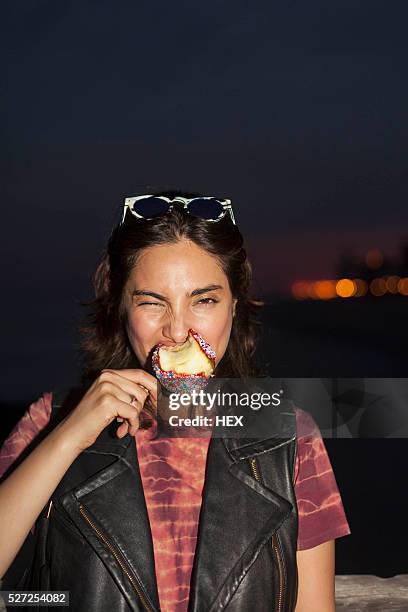 young woman enjoying a candy apple - toffee stock pictures, royalty-free photos & images