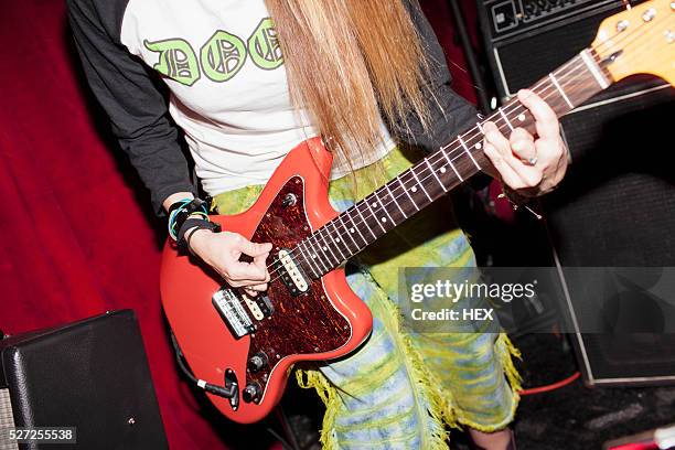 young woman playing an electric guitar - woman electric guitar stock pictures, royalty-free photos & images