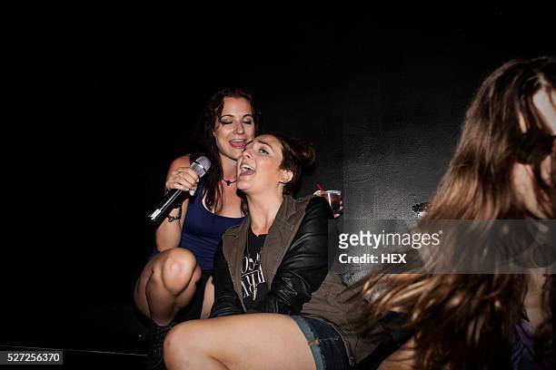 friends doing karaoke at a nightclub - karaoke stock pictures, royalty-free photos & images