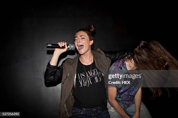 friends doing karaoke at a nightclub - karaoke stock pictures, royalty-free photos & images
