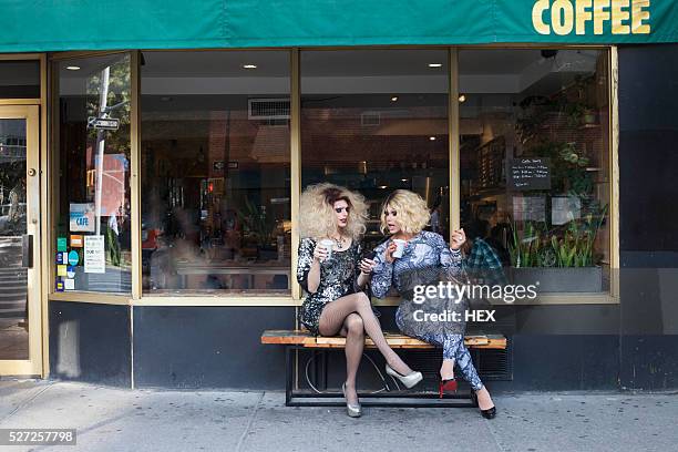 two drag queens sitting drinking coffee - drag queens stock pictures, royalty-free photos & images
