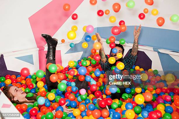 friends playing in a ball pit - ball pit stock pictures, royalty-free photos & images