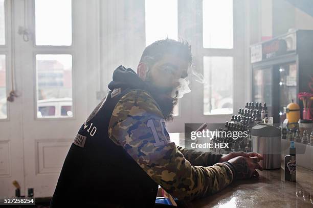 young man smoking - vaper stock pictures, royalty-free photos & images