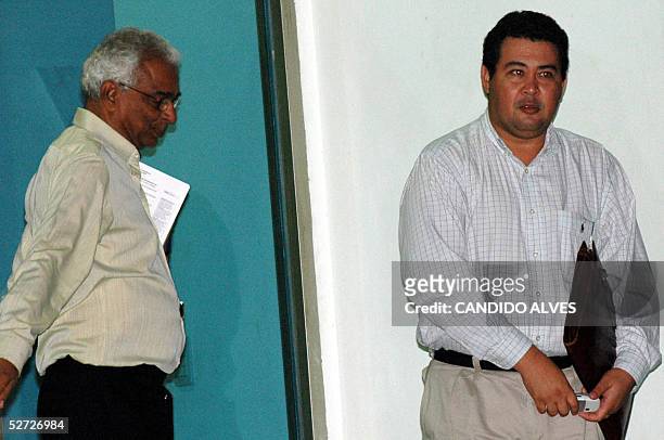 Jose Teixeira State Secretary for tourism, environment and oil comes out from a meeting room as Australian official stands after a meeting in Dili,...