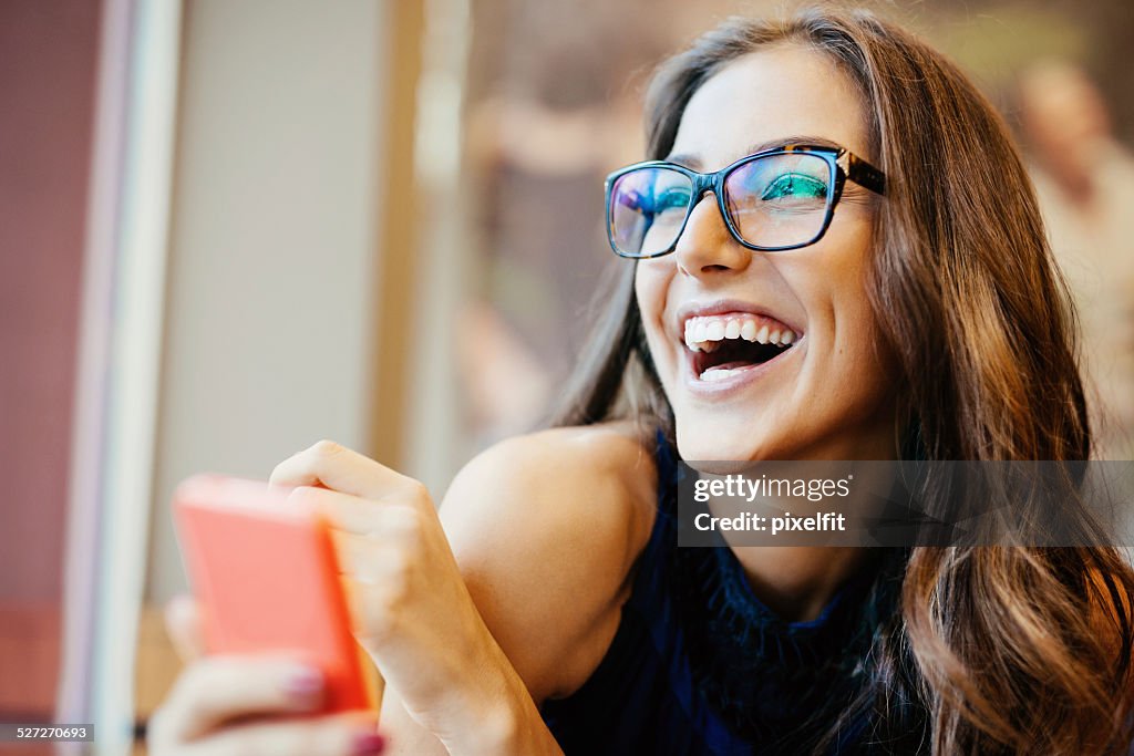 Young woman texting on smart phone