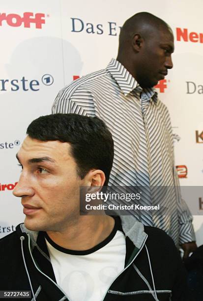 Eliseo Castillo of Cuba walks behind Wladimir Klitschko of Ukraine during a press conference on April 18, 2005 in Dortmund, Germany. Wladimir...