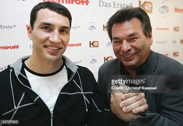 Television moderator Waldemar Hartmann shakes hands with Wladimir Klitschko of Ukraine during a press conference on April 18, 2005 in Dortmund,...