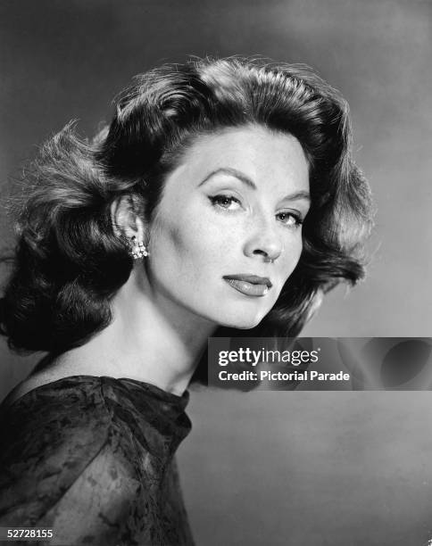 Portrait of American model and actress Suzy Parker as she looks to her right, late 1950s.