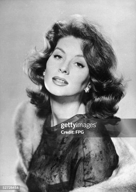 American model and actress Suzy Parker poses with a fur stole, late 1950s.