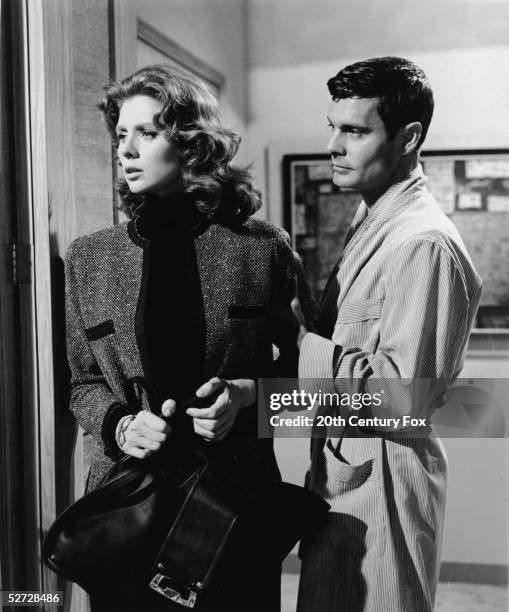 American model and actress Suzy Parker and French actor Louis Jourdan perform in a still from the film 'The Best of Everything,' directed by Jean...
