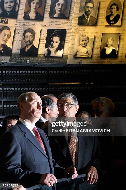 Russian President Vladimir Putin and Avner Shalev, director of the Yad Vashem Holocaust Memorial Museum are seen under the conical-shaped roof of the...