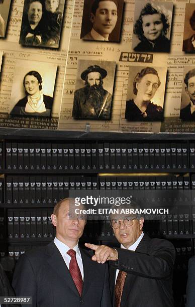 Russian President Vladimir Putin and Avner Shalev, director of the Yad Vashem Holocaust Memorial Museum are seen under the conical-shaped roof of the...