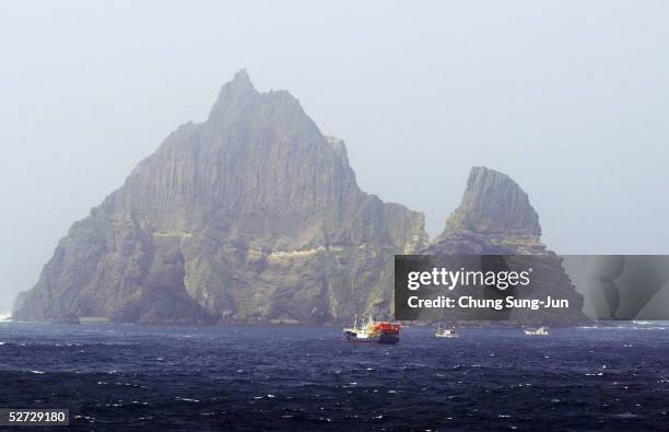 One of the Dokdo Islets, known by the Japanese as the Takeshima Islands, is seen from a South Korean coast guard ship as it sails close to the...