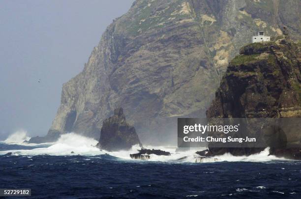 One of the Dokdo Islets, known by the Japanese as the Takeshima Islands, is seen from a South Korean coast guard ship as it sails close to the...