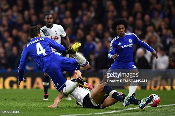 Tottenham Hotspur's Argentinian midfielder Erik Lamela fouls Chelsea's Spanish midfielder Cesc Fabregas to earn a yellow card during the English...