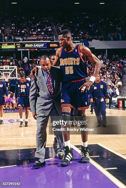 Dikembe Mutombo and Bernie Bickerstaff of the Denver Nuggets walk against the Sacramento Kings circa 1996 at Arco Arena in Sacramento, California....