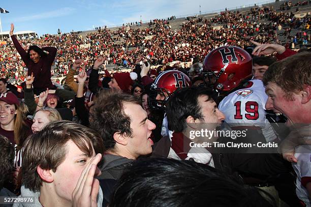 Harvard players and fans celebrate victory after the Yale V Harvard, Ivy League Football match at Yale Bowl. Harvard won the game 34-7 giving Harvard...
