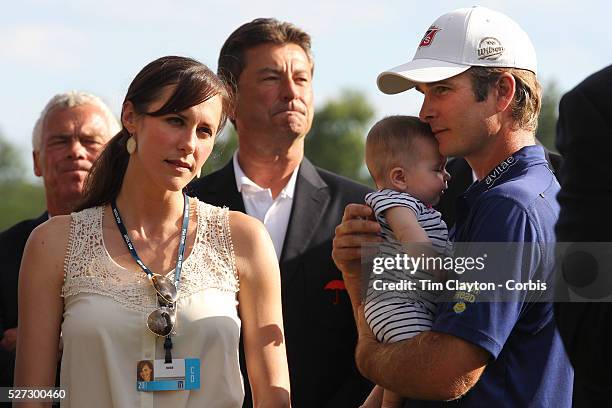 Kevin Streelman holding his 6-month-old daughter Sophia, watched by his wife Courtney after winning the Travelers Championship at the TPC River...