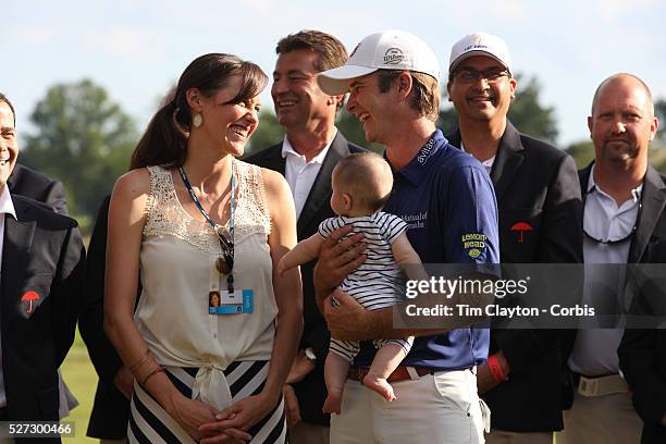 Kevin Streelman holding his 6-month-old daughter Sophia, watched by his wife Courtney after winning the Travelers Championship at the TPC River...