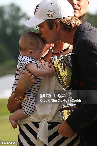 Kevin Streelman kisses his 6-month-old daughter Sophia, watched by his wife Courtney after winning the Travelers Championship at the TPC River...