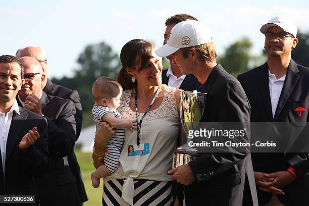Kevin Streelman with his wife, Courtney, who is holding their 6-month-old daughter, Sophia, after winning the Travelers Championship at the TPC River...