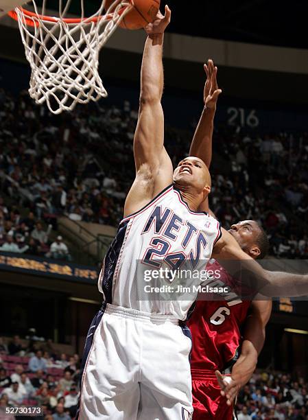 Richard Jefferson of the New Jersey Nets dunks past Eddie Jones of the Miami Heat in Game three of the Eastern Conference Quarterfinals during the...