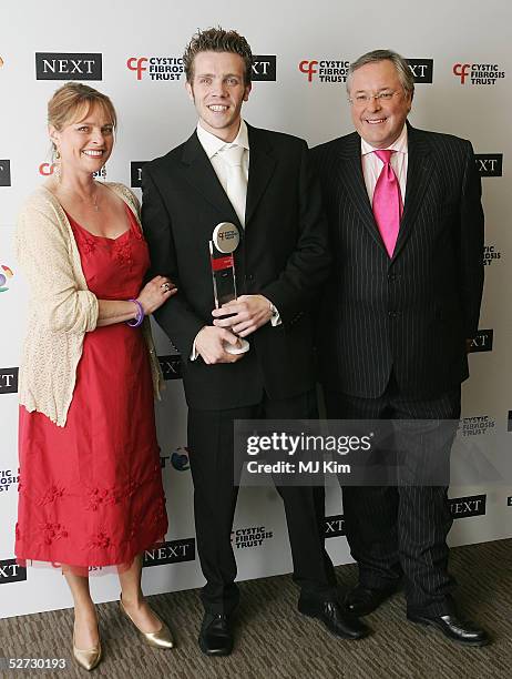 Presenters Janet Ellis and Richard Whiteley pose with 27-year-old Tony O'Brien, recipient of the Adult Artistic Award at the Cystic Fibrosis Trust...