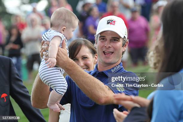 Kevin Streelman holding his 6-month-old daughter Sophia, watched by his wife Courtney after winning the Travelers Championship at the TPC River...