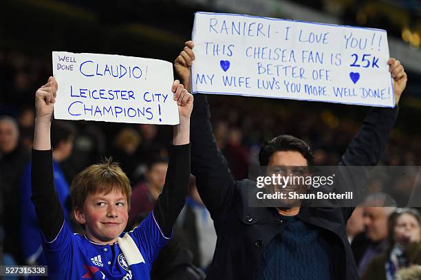 Chelsea fans hold up banners celebrating Leicester City being crowned champions following the 2-2 draw during the Barclays Premier League match...