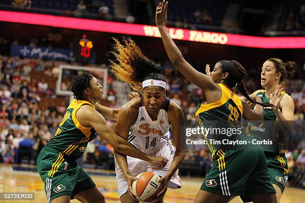 Kelsey Bone, , Connecticut Sun, derives to the basket defended by Tanisha Wright, and Camille Little, Seattle Storm, during the Connecticut Sun Vs...