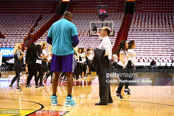 Assistant Coach Patrick Ewing of the Charlotte Hornets chats with Announcer Jeff Van Gundy prior to Game Seven of the Eastern Conference...