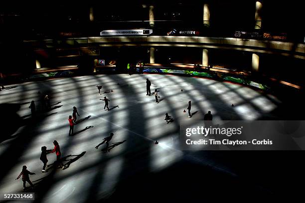Patterns of light and shade cover the ice at Lotte World Indoor Ice Rink, Seoul, Korea, as young aspiring South Korean girls train under the watchful...