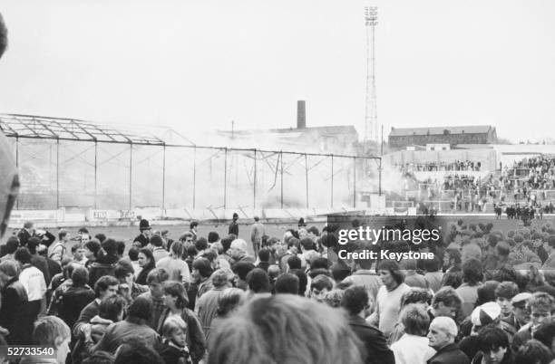 Crowds on the pitch at Bradford City's Valley Parade stadium after the stand caught fire. In less than five minutes the whole Main Stand was ablaze...