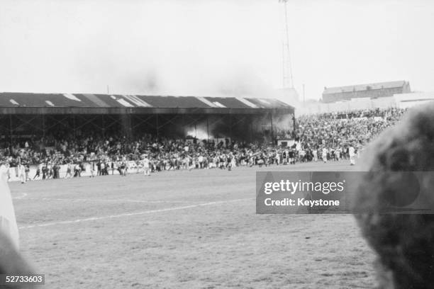 Crowds on the pitch at Bradford City's Valley Parade stadium after the stand caught fire. In less than five minutes the whole Main Stand was ablaze...