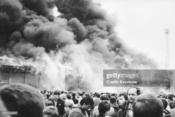 Crowds on the pitch at Bradford City's Valley Parade stadium after the stand caught fire. In less than five minutes the whole Main Stand was ablaze...