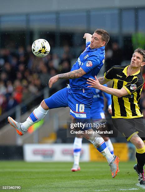 Shane Cansdell-Sherriff of Burton Albion tackles Cody McDonald of Gillingham during the Sky Bet League One match between Burton Albion and Gillingham...