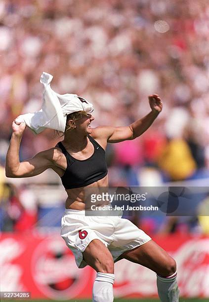 Brandi Chastain of Team USA removes her jersey while celebrating after kicking the winning penalty shot to win the Final match over Team China during...