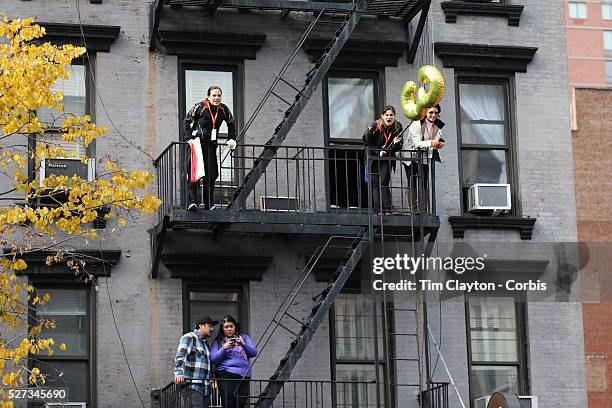 Spectators watch from vantage points as runners make their way along First Avenue in Manhattan, New York, during the ING New York Marathon. New York,...