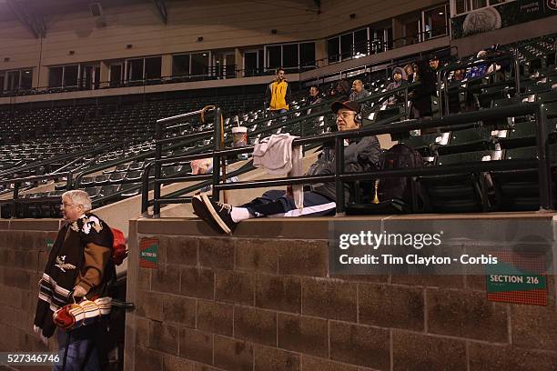 Fans in the stands on a cold and wet evening during the Rochester Red Wings V The Scranton/Wilkes-Barre RailRiders, Minor League ball game at...