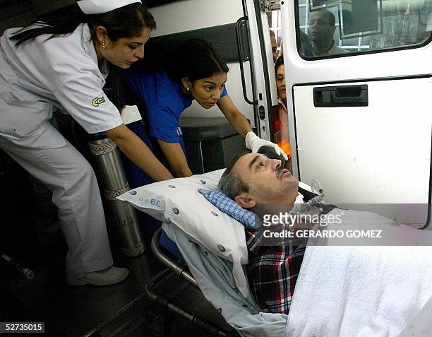 Luis Fernando Montoya, ex tecnico del Club Once Caldas, actual campeon de la Copa Libertadores, es transportado por enfermeras a la ambulancia que lo...