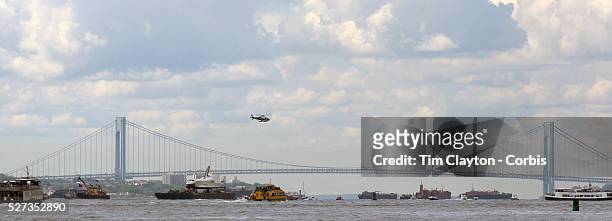 The Space Shuttle Enterprise passes lower Manhattan on a barge along the Hudson River as it completes her journey to the Intrepid Sea, Air and Space...
