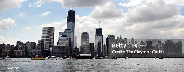 The Space Shuttle Enterprise passes the One World Trade Centre and lower Manhattan on a barge along the Hudson River as it completes her journey to...