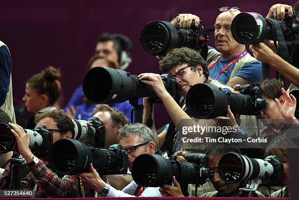 Photographers shoot Gold Medalist Epke Zonderland, The Netherlands, in the Men's Apparatus - Horizontal Bar Final at North Greenwich Arena during the...