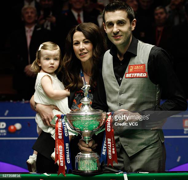 Mark Selby of England celebrates with wife Nikki and daughter Sophia after beating Ding Junhui of China to win the World Snooker Championship final...